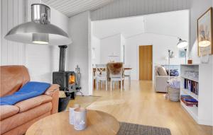 a living room with a couch and a table at 2 Bedroom Beautiful Home In Gilleleje in Gilleleje
