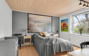 a bedroom with a bed and a painting on the wall at Awesome Home In Slagelse With Kitchen in Slagelse +12 photos