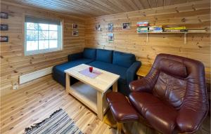 a living room with a blue couch and a table at 5 Bedroom Pet Friendly Home In Jordet in Jordet +11 photos