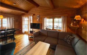a living room with a couch and a table at 5 Bedroom Pet Friendly Home In Jordet in Jordet