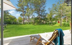 a rocking chair on a deck with a playground at Stunning Home In Sjællands Odde in Yderby +23 photos