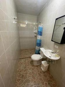 a bathroom with a toilet and a sink at Finca Kikua in San Rafael
