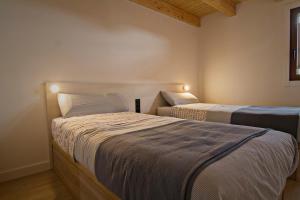 a bedroom with two beds with lights on them at 4cases4Gironella in Gironella