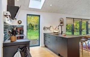 a kitchen with a sink and a counter top at 3 Bedroom Nice Home In Fårevejle in Fårevejle