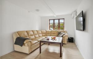 a living room with a couch and a coffee table at 1 Bedroom Nice Home In Rudkøbing in Rudkøbing