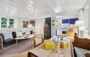a living room with a couch and a table at 3 Bedroom Gorgeous Home In Nexø in Neksø