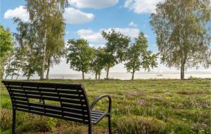 a park bench sitting in a field with trees at 2 Bedroom Gorgeous Home In Højslev in Højslev +11 photos