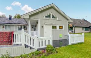 a house with a white fence and a porch at 1 Bedroom Amazing Apartment In Ljungby in Ljungby