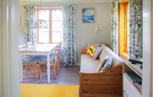 a living room with a couch and a table at Holiday Home Bosebyn Nordfalla Gunnarskog in Gunnarskog