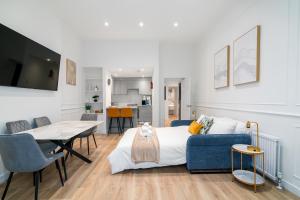 a room with a bed and a table and a couch at Luxury 2 bed Flat in Notting Hill in London