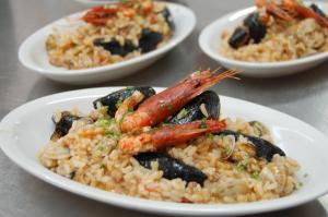 a plate of food with mussels and rice on a table at Family Resort Cala di Luna in Marina di Camerota +19 photos
