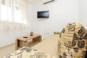 a living room with a couch and a table at Imperium Apartments in Dubrovnik