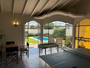 a living room with a view of a pool at Hotel Santa Catalina in Río Cuarto