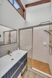 a bathroom with a shower and a sink at Unit 5 13 Short Street, Merimbula in Merimbula