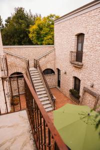 a staircase with a green umbrella next to a building at Hotel Casa Mexicana in Mineral de Pozos