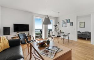 a living room with a couch and a table at Awesome Apartment In Allinge With Wifi in Allinge