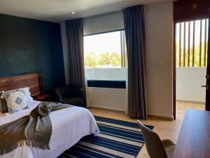Postel nebo postele na pokoji v ubytování HOTEL MINA REAL MATEHUALA