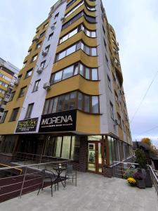 a tall building with a table in front of it at Spacious apartment with terrace in Chişinău
