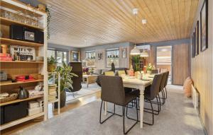 a dining room with a table and chairs at Holiday Home Bøsholmstien Glesborg Denm in Fjellerup Strand