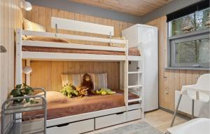 a bunk bed in a room with wooden walls at Holiday Home Bøsholmstien Glesborg Denm in Fjellerup Strand +16 photos