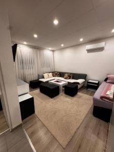 a living room with a couch and a table at Guest House deluxe in Orašje +81 photos