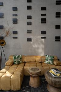 Una sala de estar con un sofá marrón y una mesa. en CASA DOM, Tranquil Retreat in San Miguel de Allende, en San Miguel de Allende