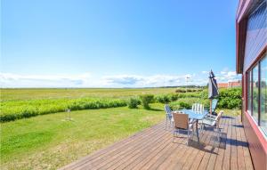 a patio with a table and chairs on a deck at Three-Bedroom Holiday Home In Karrebaksminde in Karrebæksminde +10 photos