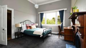a bedroom with a bed and a window at Jills Daylesford in Daylesford