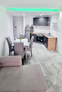 a living room with a table and chairs and a kitchen at Cristianos in Los Cristianos +72 photos