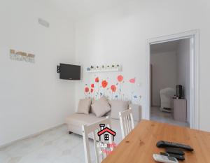 a living room with a table and a couch at Casa Bianca bnb,Big Terrace,10 min Airport Beaches in Bitonto