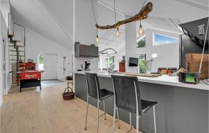 a kitchen with a counter and some chairs in it at Pet Friendly Home In Vordingborg in Vordingborg