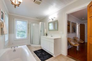 a bathroom with a tub and a sink and a shower at Bluffton Breeze-3BR Heart of Old Town Village Home in Bluffton