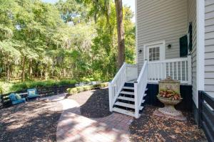 a white staircase leading to a house with trees at Bluffton Breeze-3BR Heart of Old Town Village Home in Bluffton +3 photos