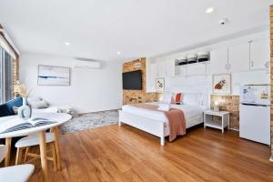 a hotel room with a bed and a table at House on the Hillside with City Views Sleeps 12 in Howrah