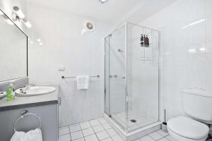 a bathroom with a shower and a toilet and a sink at House on the Hillside with City Views Sleeps 12 in Howrah
