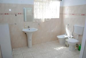 a bathroom with a sink and a toilet at Tambarina Guest House in Mindelo +26 photos