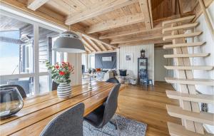 a dining room with a wooden table and chairs at 4 Bedroom Nice Home In Tustna in Leira