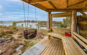 a porch of a cabin with a view of a lake at 4 Bedroom Nice Home In Tustna in Leira +14 photos