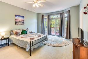 a bedroom with a bed and a tv at Lakefront Hartwell Retreat with Gas Grill and Deck! in Hartwell