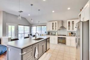 a kitchen with white cabinets and a counter top at Spacious 4BR Home Away From Home with Hot Tub in Austin +21 photos