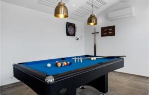 a pool table in a room with two lights at Awesome Home In Hvide Sande With Sauna in Bjerregård +50 photos