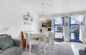 a dining room with a white table and chairs at 2 Bedroom Lovely Apartment In Nexø in Neksø