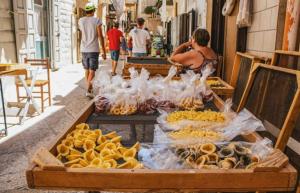 a market with various types of food on a street at A&A B&B Piccinni in Bari