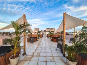 a patio with chairs and plants on a roof at Atlântico Sul Hotel in Porto De Galinhas