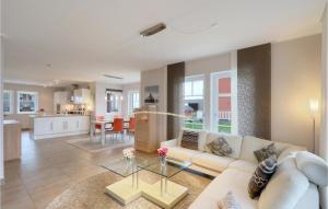 a living room with a couch and a table at Unendliche See in Olpenitz