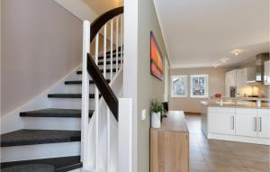 a kitchen and living room with a staircase in a house at Unendliche See in Olpenitz +28 photos