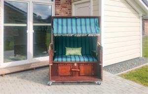 an old chair sitting in front of a house at Lovely Home In Dagebüll With Sauna in Dagebüll