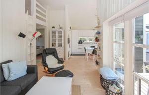 a living room with a couch and a table at Gorgeous Home In Samsø With Kitchen in Onsbjerg