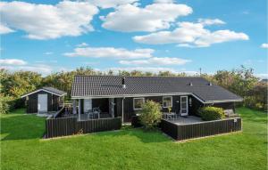 a small black house with a green yard at Awesome Home In Tarm With Sauna in Tarm +28 photos