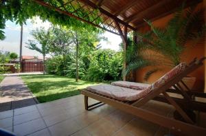 a porch with a hammock on a patio at Villa Viola Spa&Garden in Gyula